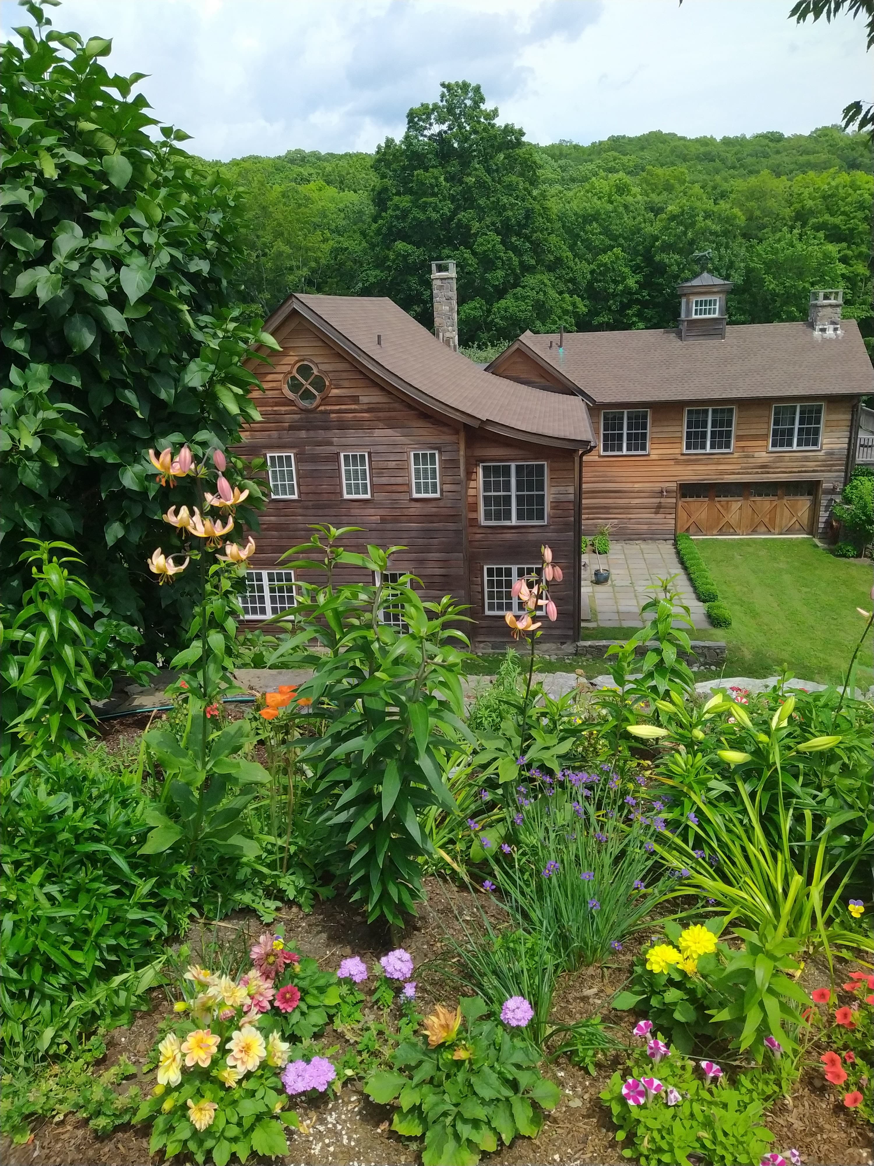 Garden and planting beds in front of barn.